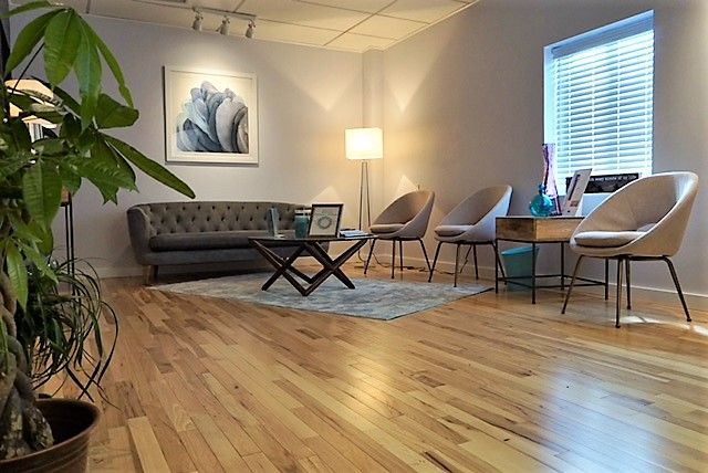 Reception room at Balencia MD's North Providence clinic, with a sofa, armchairs and natural light