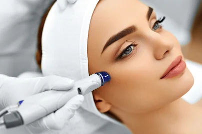 Client having a facial treatment with a handheld device